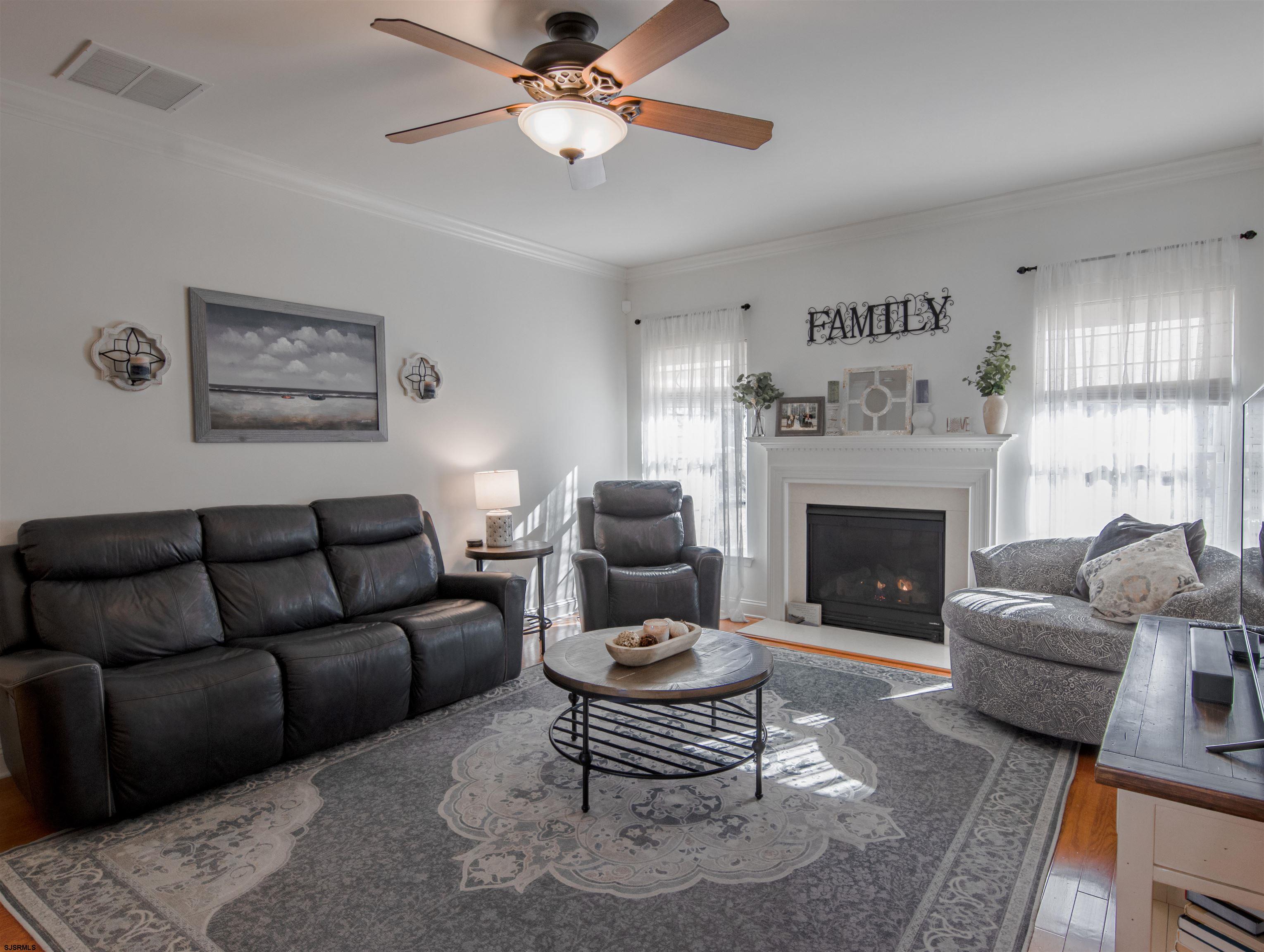 307 Gosling Way Glassboro, NJ 08028 - Photo 4 of 7 a living room with furniture a fireplace and a large window