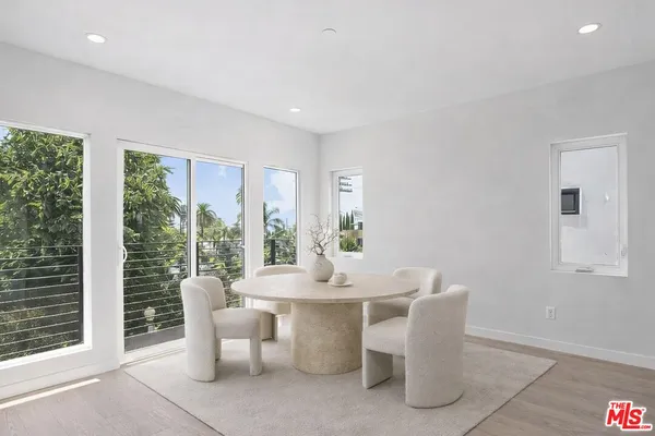 a dining room with furniture and wooden floor