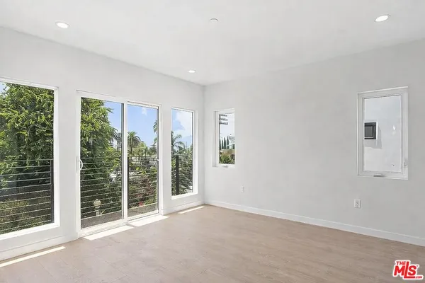 a view of an empty room with windows