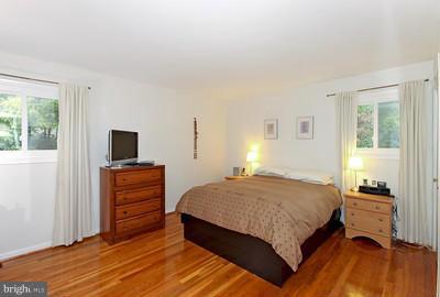 13020 Tamarack Road Silver Spring, MD 20904 - Photo 14 of 25 a bedroom with a bed and wooden floor