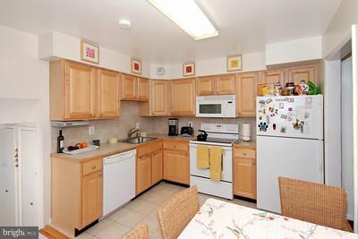 13020 Tamarack Road Silver Spring, MD 20904 - Photo 4 of 25 a kitchen with stainless steel appliances granite countertop a refrigerator sink and white cabinets