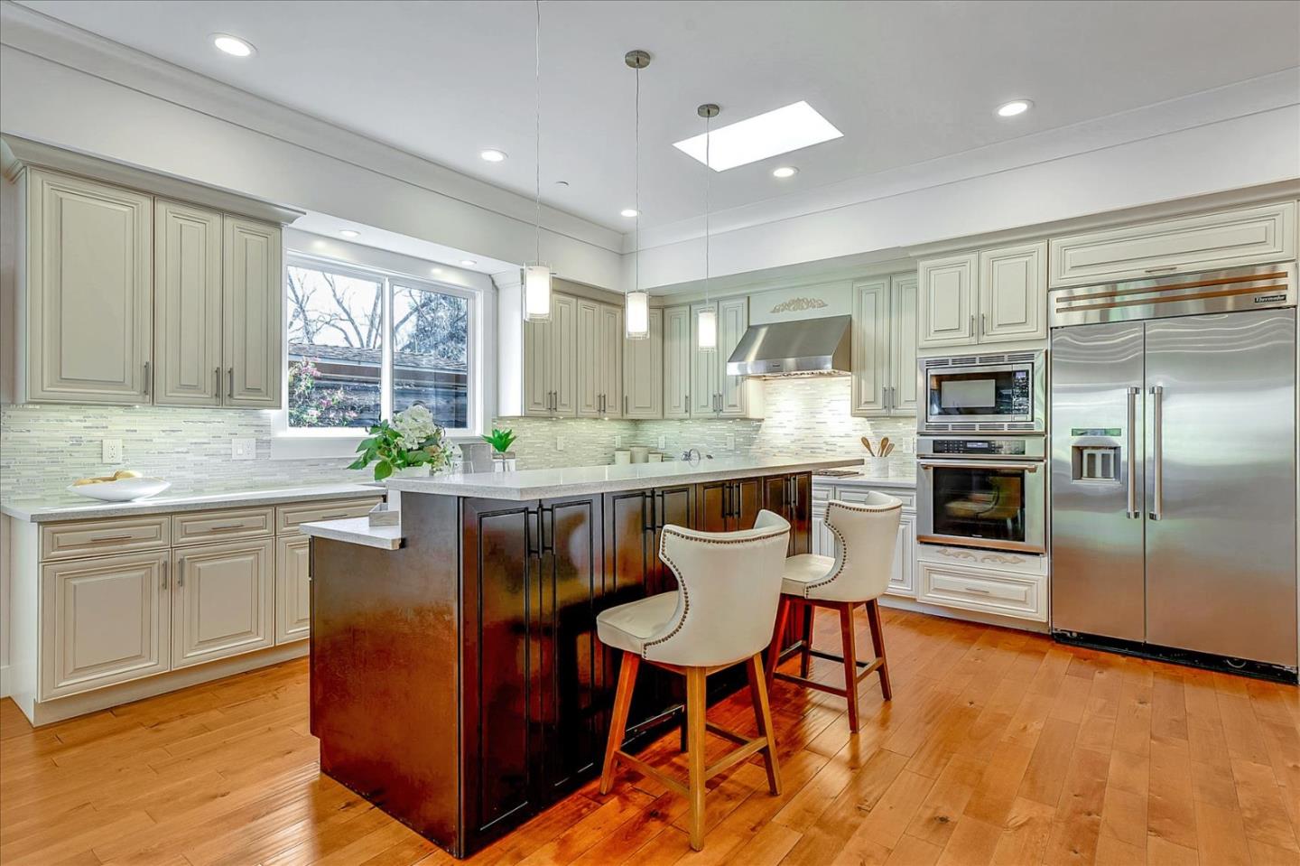 10380 Sterling Boulevard Cupertino, CA 95014 - Photo 12 of 49 a kitchen with granite countertop a counter space dining table stainless steel appliances and a window