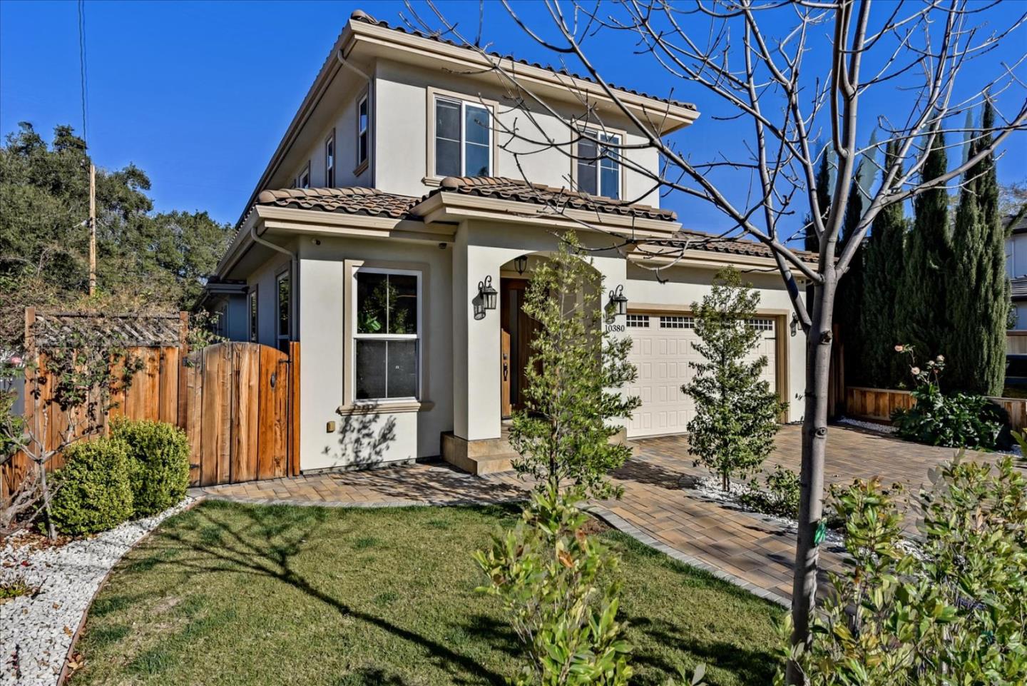10380 Sterling Boulevard Cupertino, CA 95014 - Photo 2 of 49 a view of a white house with large windows and a small yard