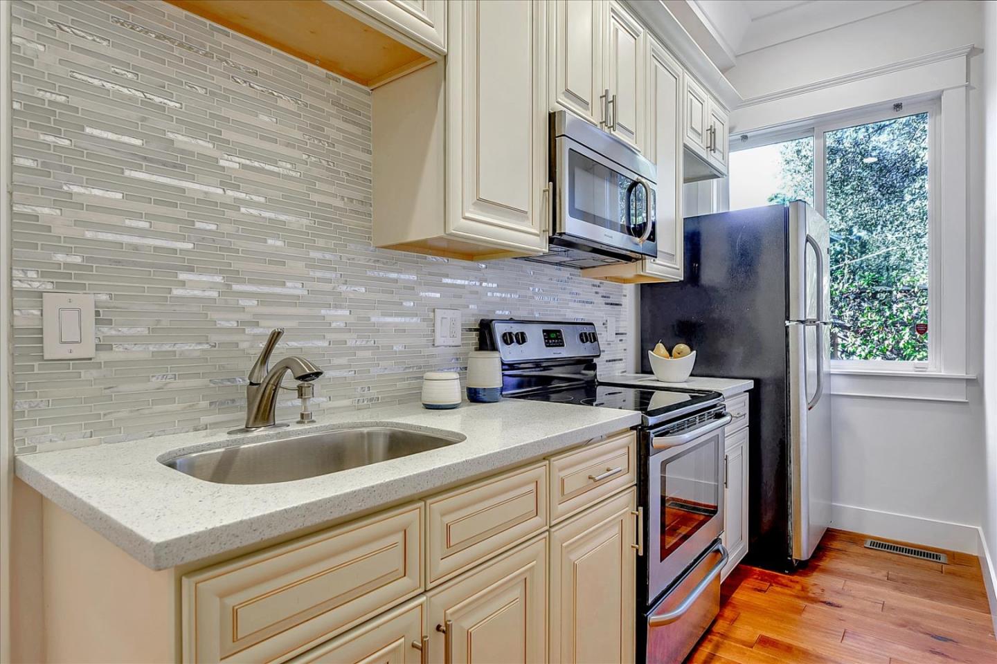10380 Sterling Boulevard Cupertino, CA 95014 - Photo 24 of 49 a kitchen with stainless steel appliances granite countertop a sink and a microwave