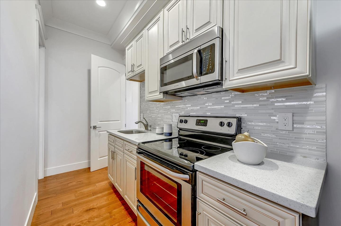 10380 Sterling Boulevard Cupertino, CA 95014 - Photo 26 of 49 a kitchen with stainless steel appliances granite countertop a stove and a microwave