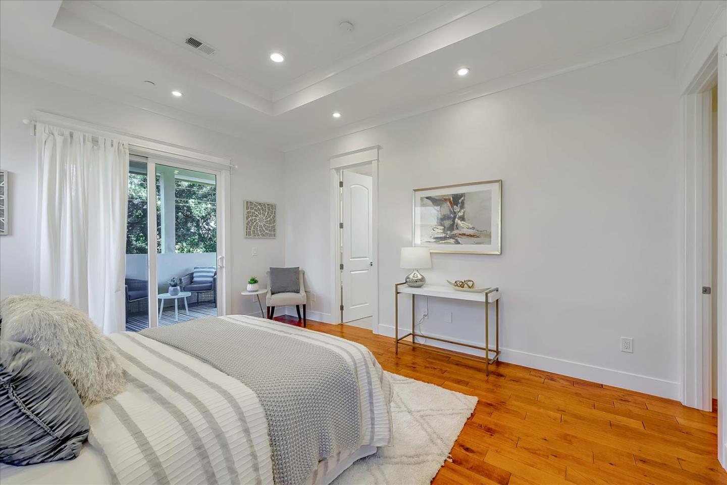 10380 Sterling Boulevard Cupertino, CA 95014 - Photo 29 of 49 a bedroom with a large bed and a chandelier