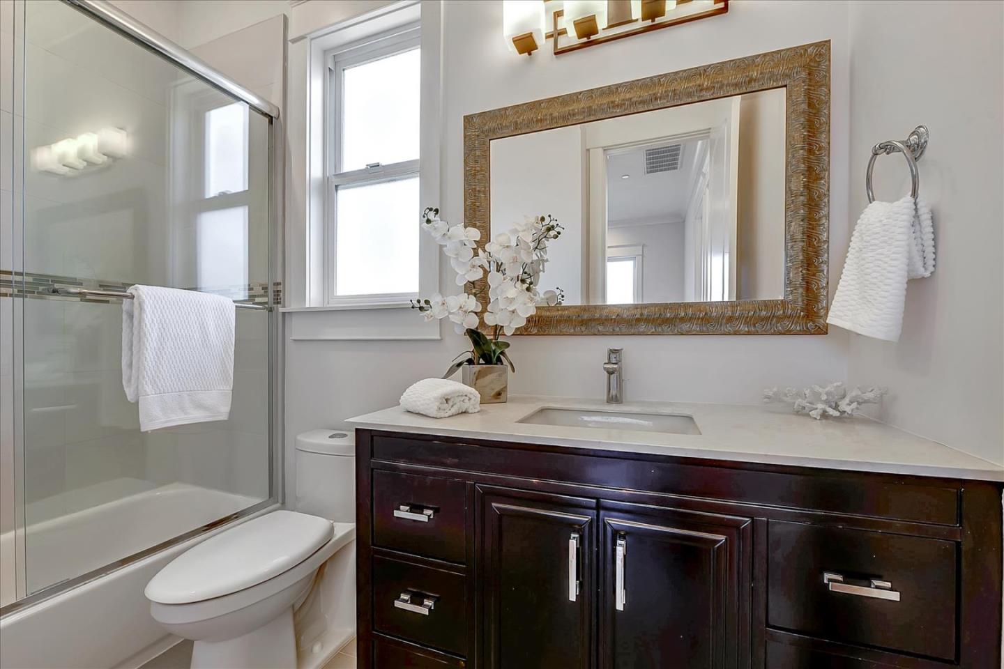 10380 Sterling Boulevard Cupertino, CA 95014 - Photo 35 of 49 a bathroom with a sink a toilet and a mirror