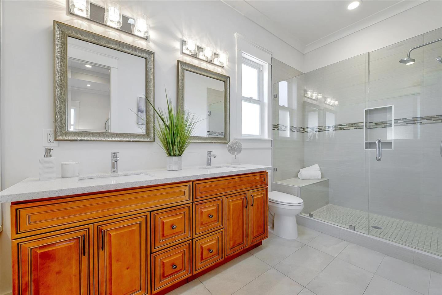 10380 Sterling Boulevard Cupertino, CA 95014 - Photo 37 of 49 a spacious bathroom with a granite countertop sink a toilet a mirror and shower