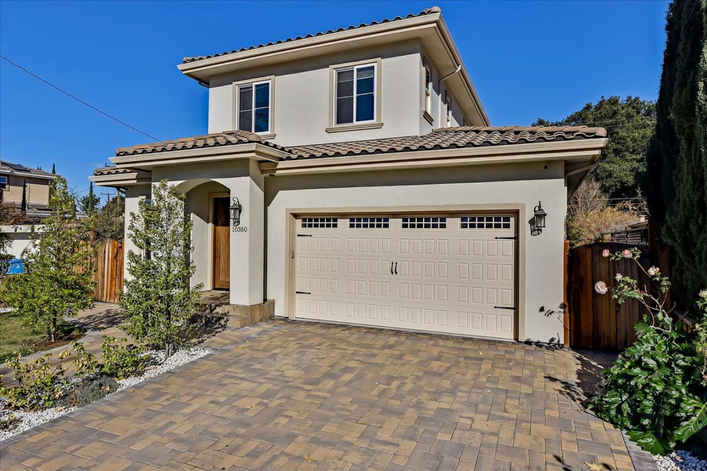 10380 Sterling Boulevard Cupertino, CA 95014 - Photo 49 of 49 a view of a white house with large windows and potted plants
