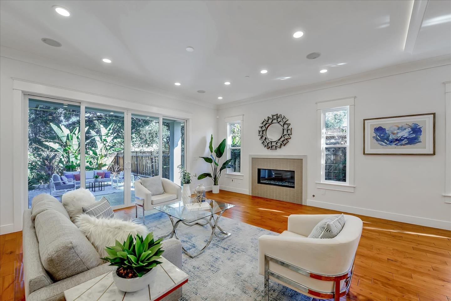 10380 Sterling Boulevard Cupertino, CA 95014 - Photo 9 of 49 a living room with furniture potted plant and a fireplace