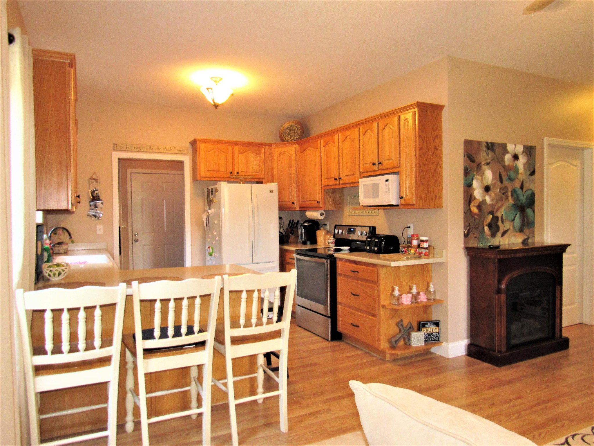 155 Fritts Road Lancing, TN 37770 - Photo 11 of 30 a kitchen with stainless steel appliances kitchen island granite countertop a refrigerator and cabinets