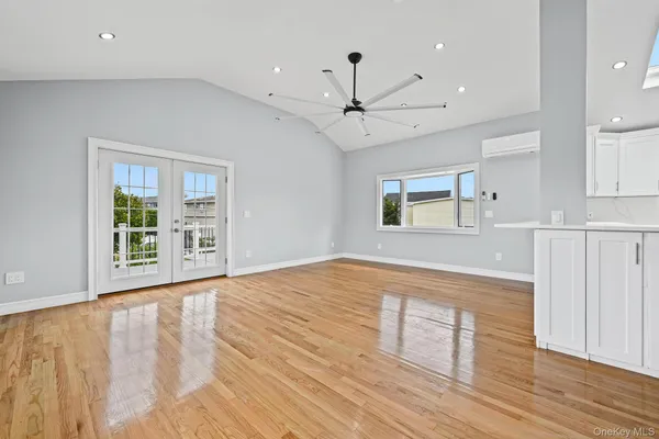 a large kitchen with cabinets and wooden floor