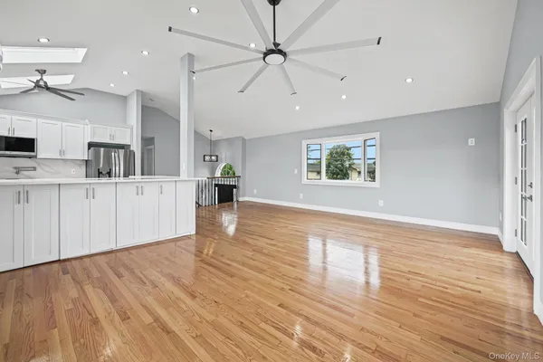 a kitchen with white cabinets appliances and sink