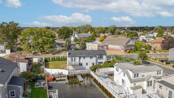 a living room with furniture kitchen view and a chandelier