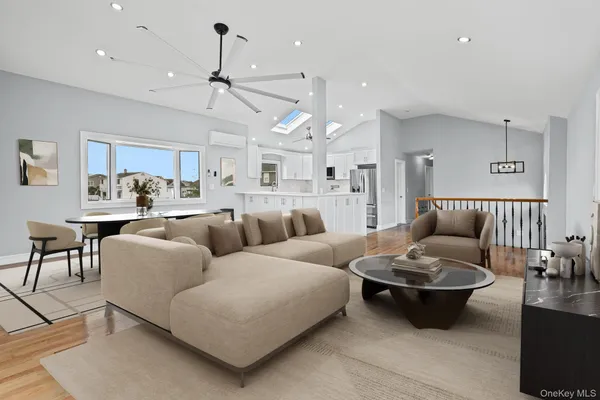 a spacious bedroom with a bed a couch and a window