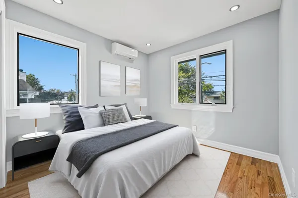 a bedroom with a bed and a large window