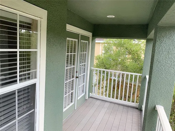 a view of balcony with a floor to ceiling window and wooden floor
