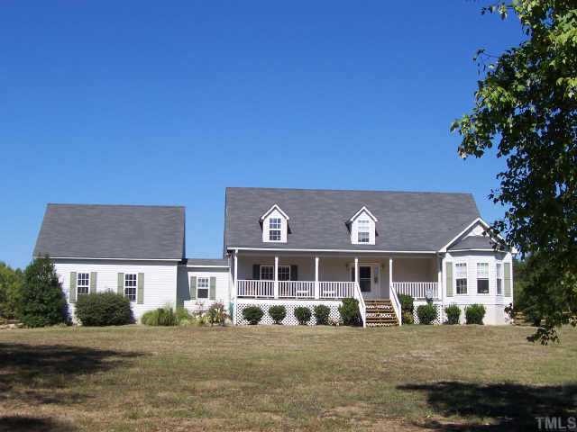 222 Robertson Road Roxboro, NC 27574 - Photo 1 of 10 a front view of a building with a garden