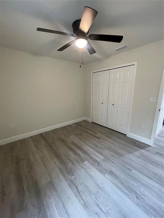 10631 North Frantz Avenue Citrus Springs, FL 34434 - Photo 14 of 21 an empty room with wooden floor and windows