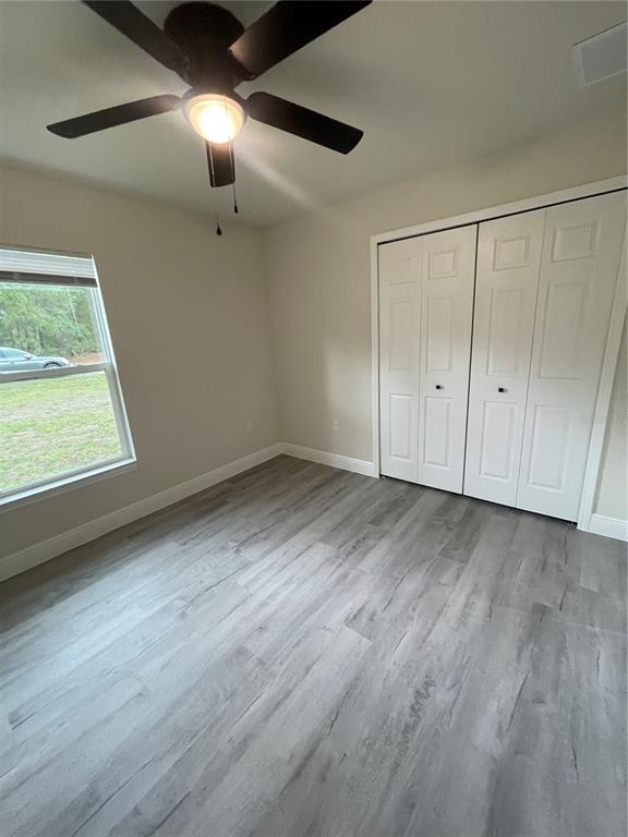 10631 North Frantz Avenue Citrus Springs, FL 34434 - Photo 15 of 21 a view of an empty room with wooden floor and a window