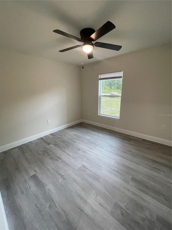 10631 North Frantz Avenue Citrus Springs, FL 34434 - Photo 16 of 21 an empty room with wooden floor and windows