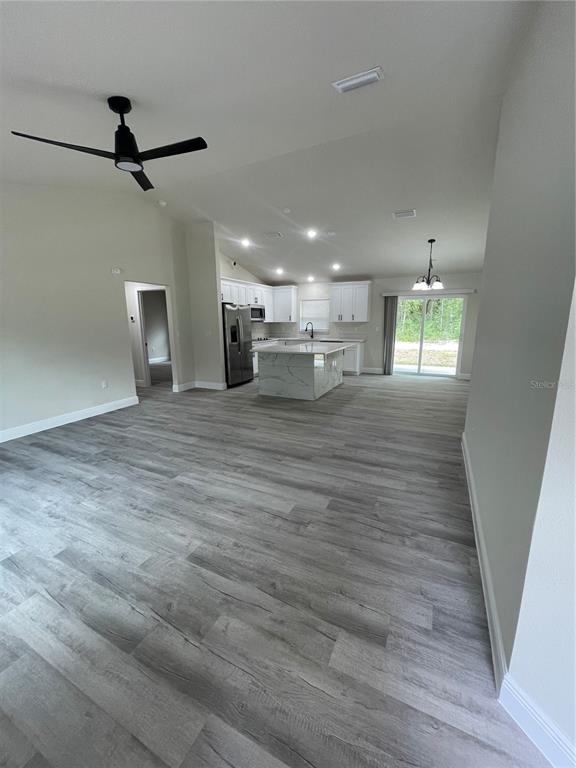 10631 North Frantz Avenue Citrus Springs, FL 34434 - Photo 2 of 21 wooden floor in an empty room with a window