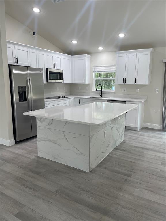 10631 North Frantz Avenue Citrus Springs, FL 34434 - Photo 4 of 21 a large kitchen with stainless steel appliances granite countertop a large counter top and a stove top oven