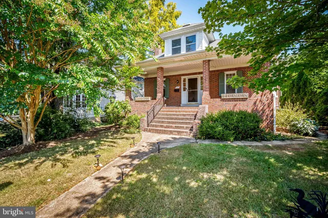 a front view of a house with a yard and porch