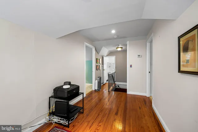 a view of a room with wooden floor and furniture