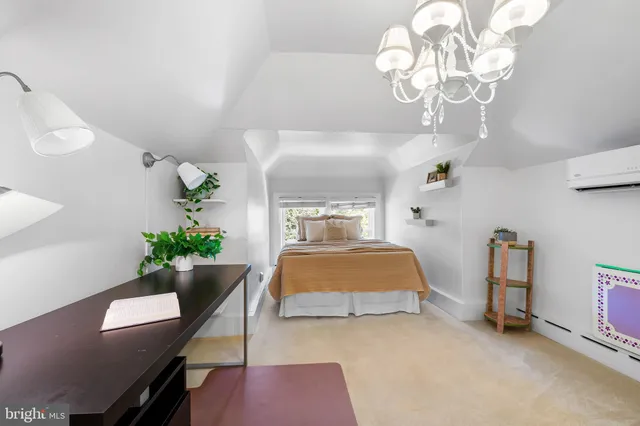 a bedroom with a bed and chandelier