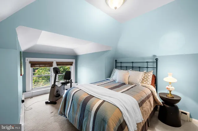 a bed room with a bed and a lamp