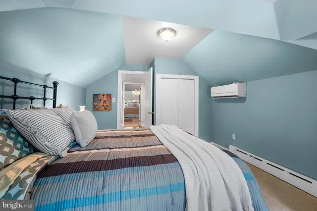 a bedroom with a bed and a lamp