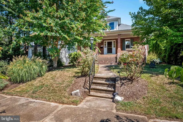 a view of house with backyard and outdoor seating