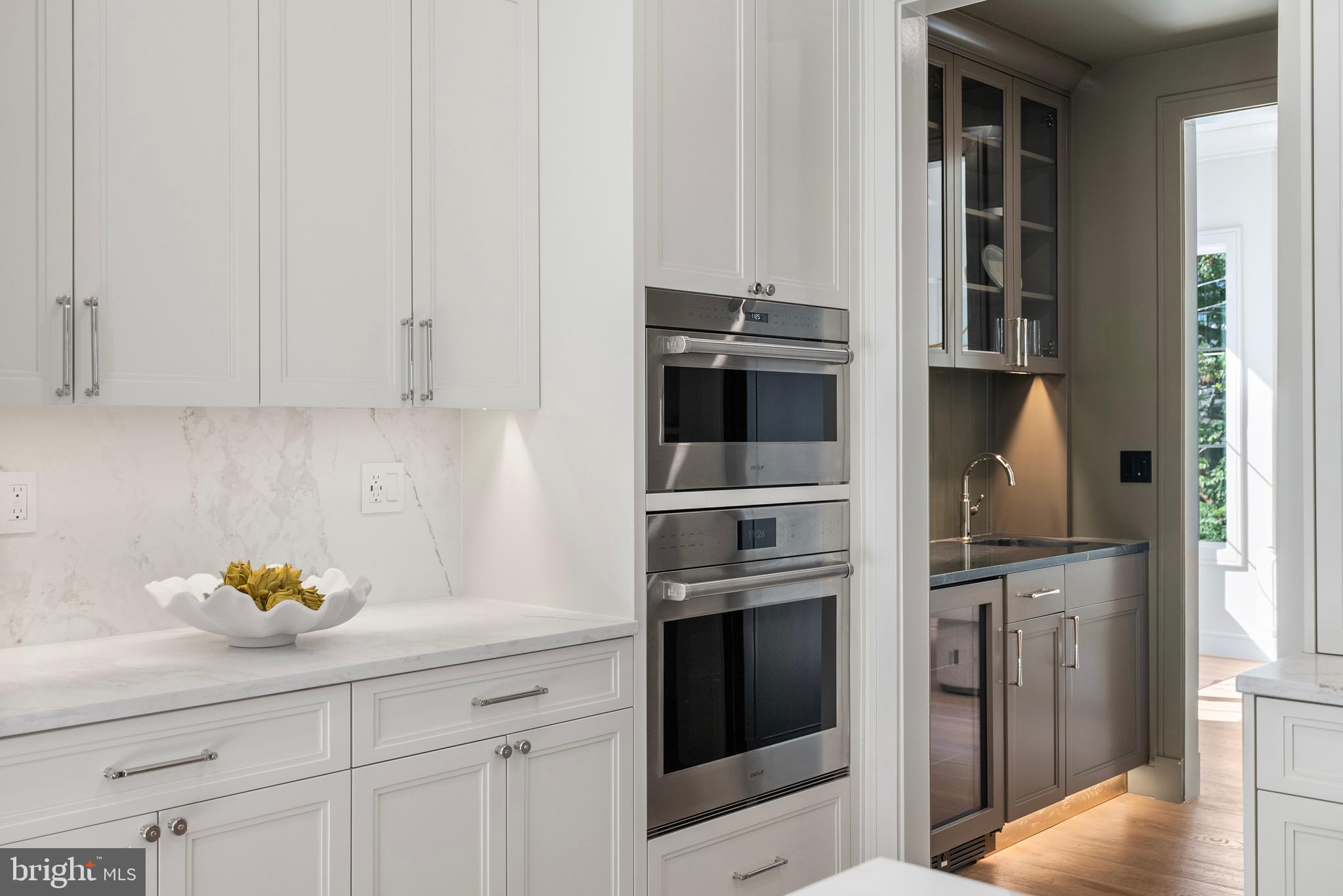 7923 Chelton Road Bethesda, MD 20814 - Photo 14 of 44 a kitchen with stainless steel appliances a stove a refrigerator and cabinets