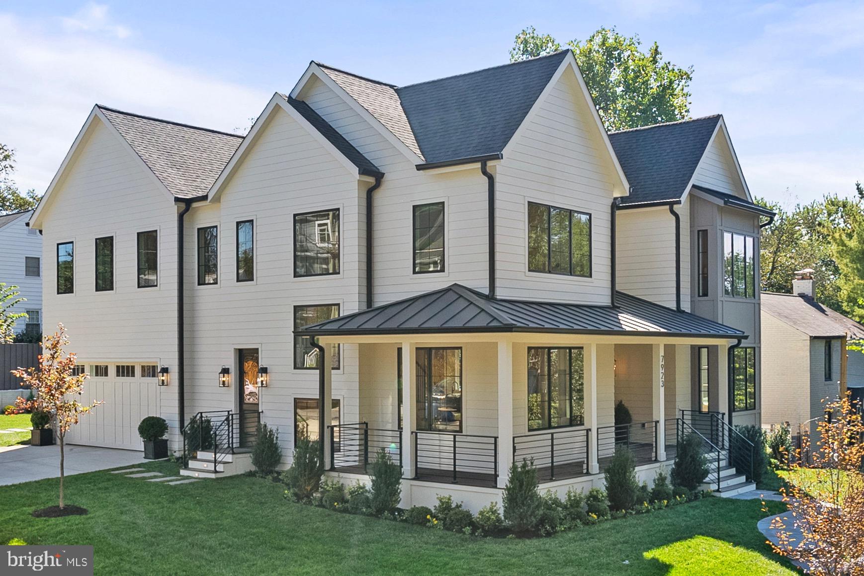 7923 Chelton Road Bethesda, MD 20814 - Photo 2 of 44 a view of a white house with large windows and a yard