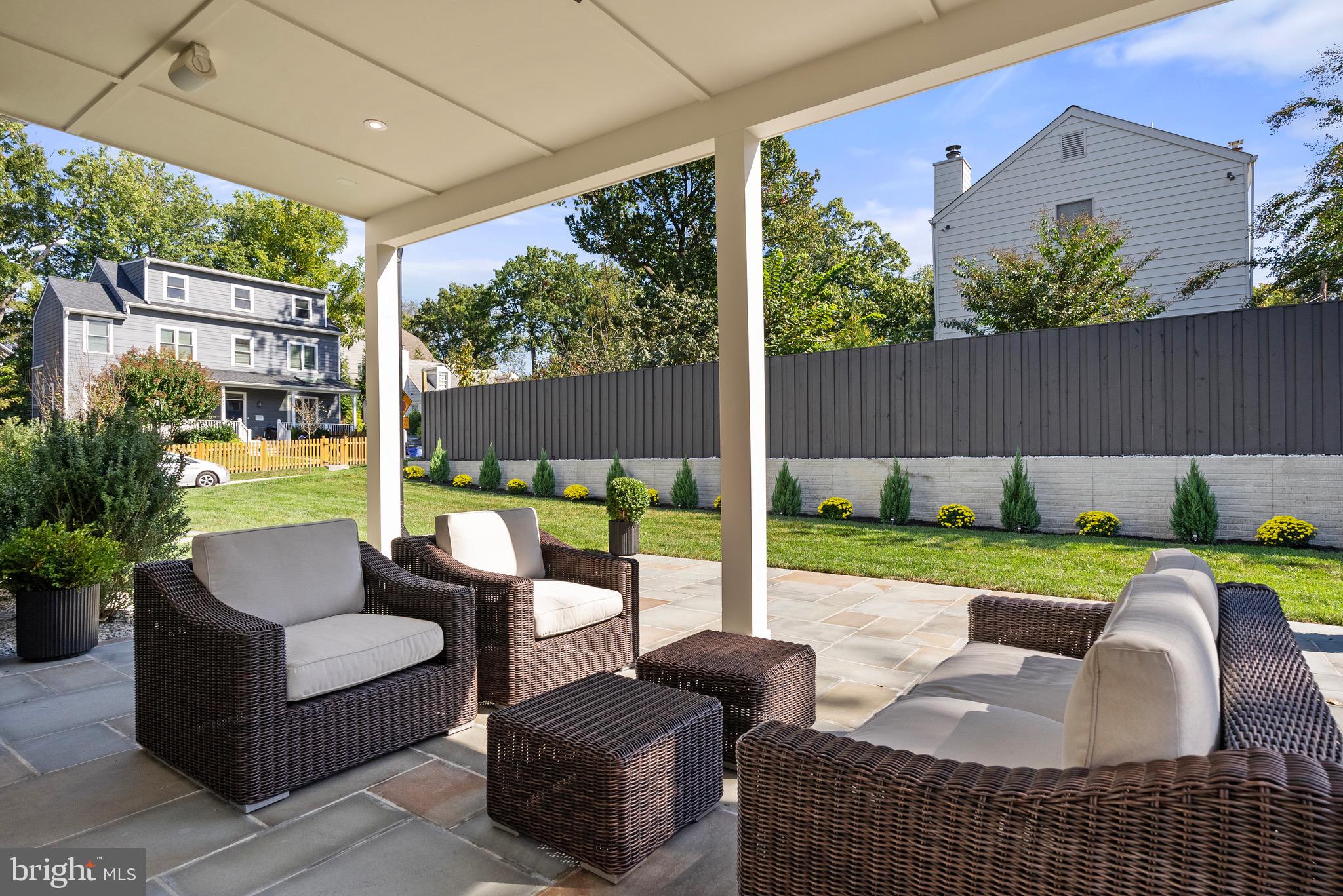 7923 Chelton Road Bethesda, MD 20814 - Photo 21 of 44 a view of a patio with couches chairs potted plants and wooden fence