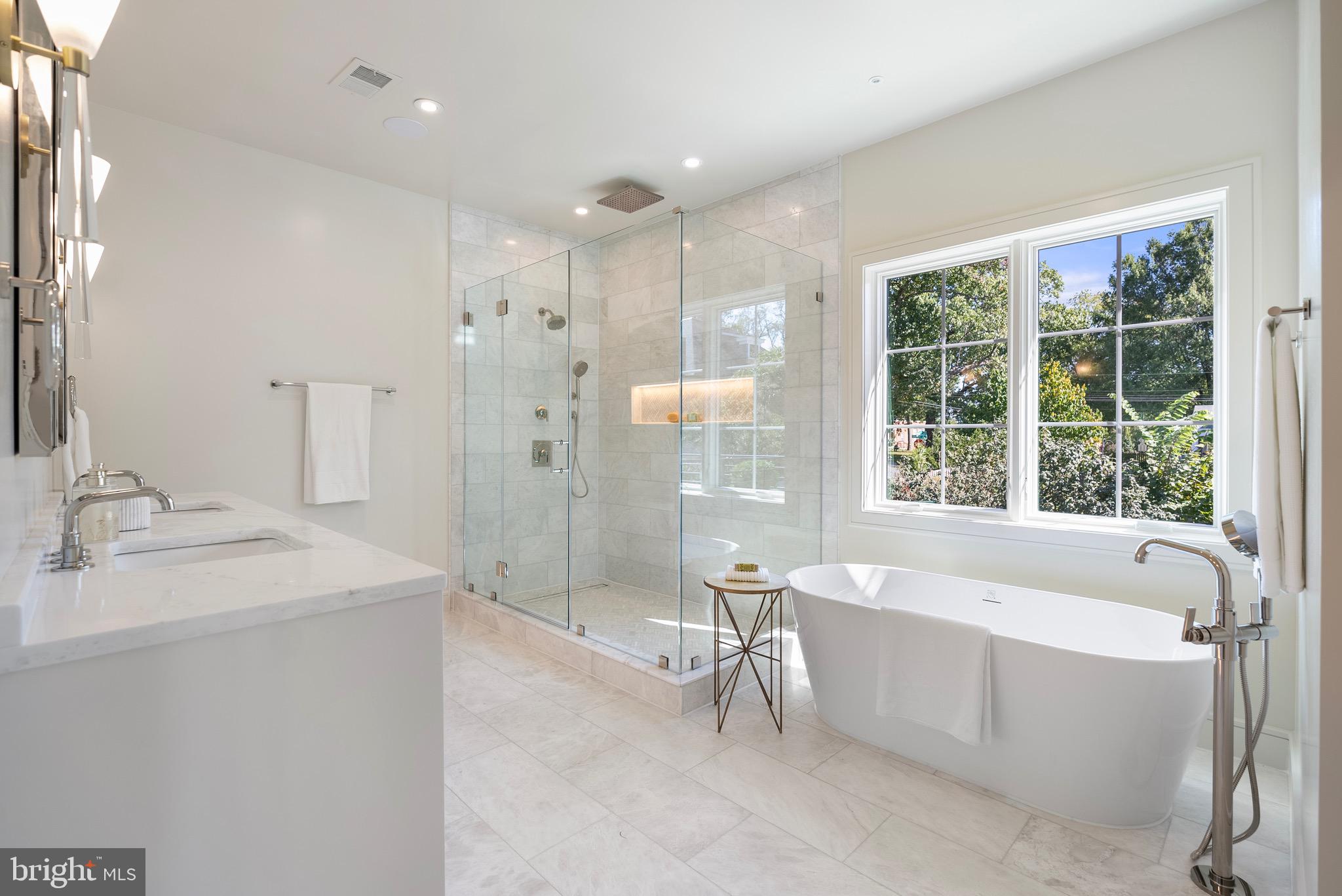 7923 Chelton Road Bethesda, MD 20814 - Photo 29 of 44 a spacious bathroom with a tub sink shower and a mirror
