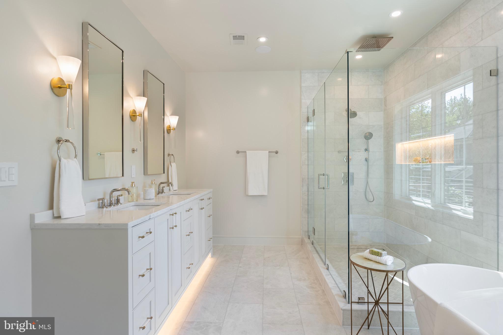 7923 Chelton Road Bethesda, MD 20814 - Photo 32 of 44 a bathroom with a double vanity sink mirror double shower and a bathtub