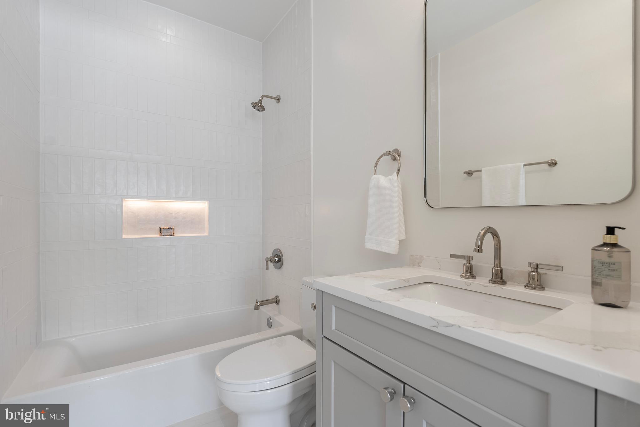 7923 Chelton Road Bethesda, MD 20814 - Photo 39 of 44 a bathroom with a granite countertop sink a toilet and shower