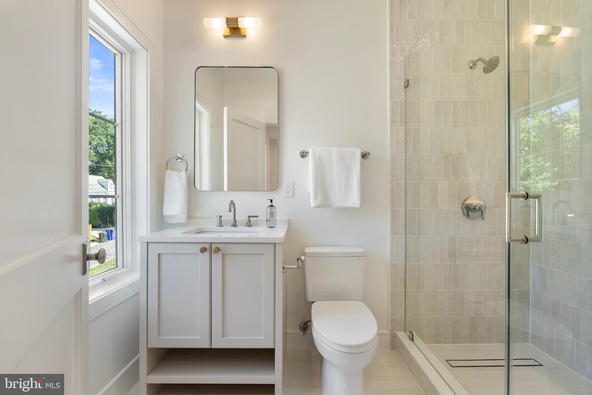 7923 Chelton Road Bethesda, MD 20814 - Photo 41 of 44 a bathroom with a sink toilet a mirror and shower
