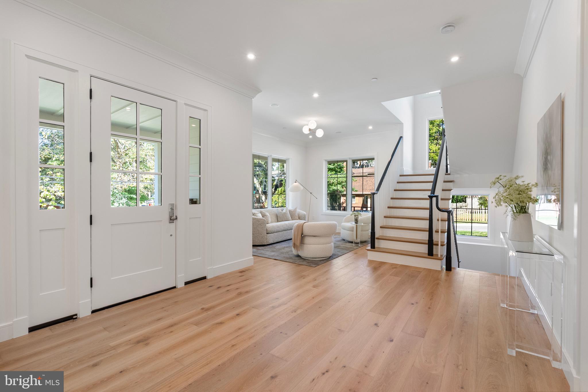 7923 Chelton Road Bethesda, MD 20814 - Photo 6 of 44 a view of an entryway with wooden floor and windows