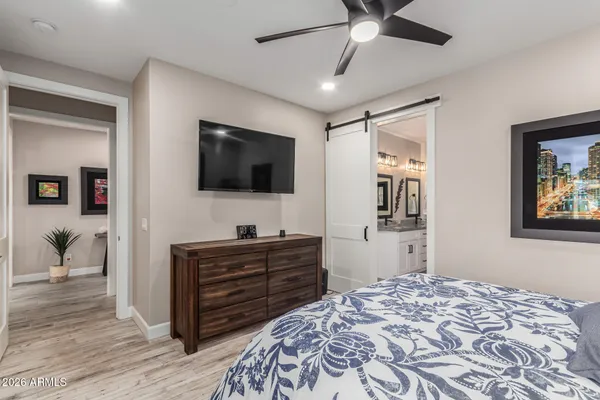 a bedroom with a bed and a flat screen tv