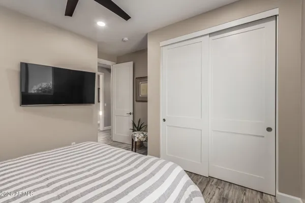 a bedroom with a bed and a flat screen tv