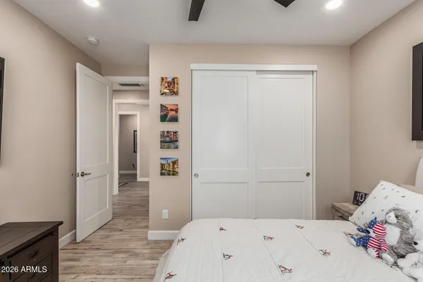 a bedroom with a bed and a refrigerator