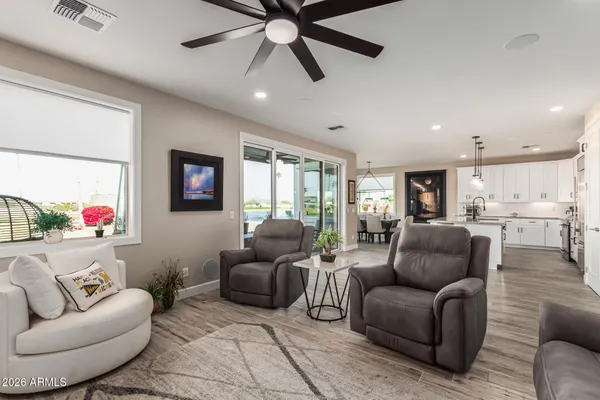 a living room with furniture and a view of kitchen