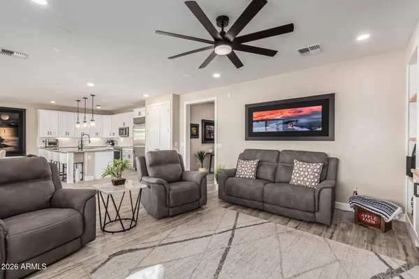 a living room with furniture and a view of kitchen