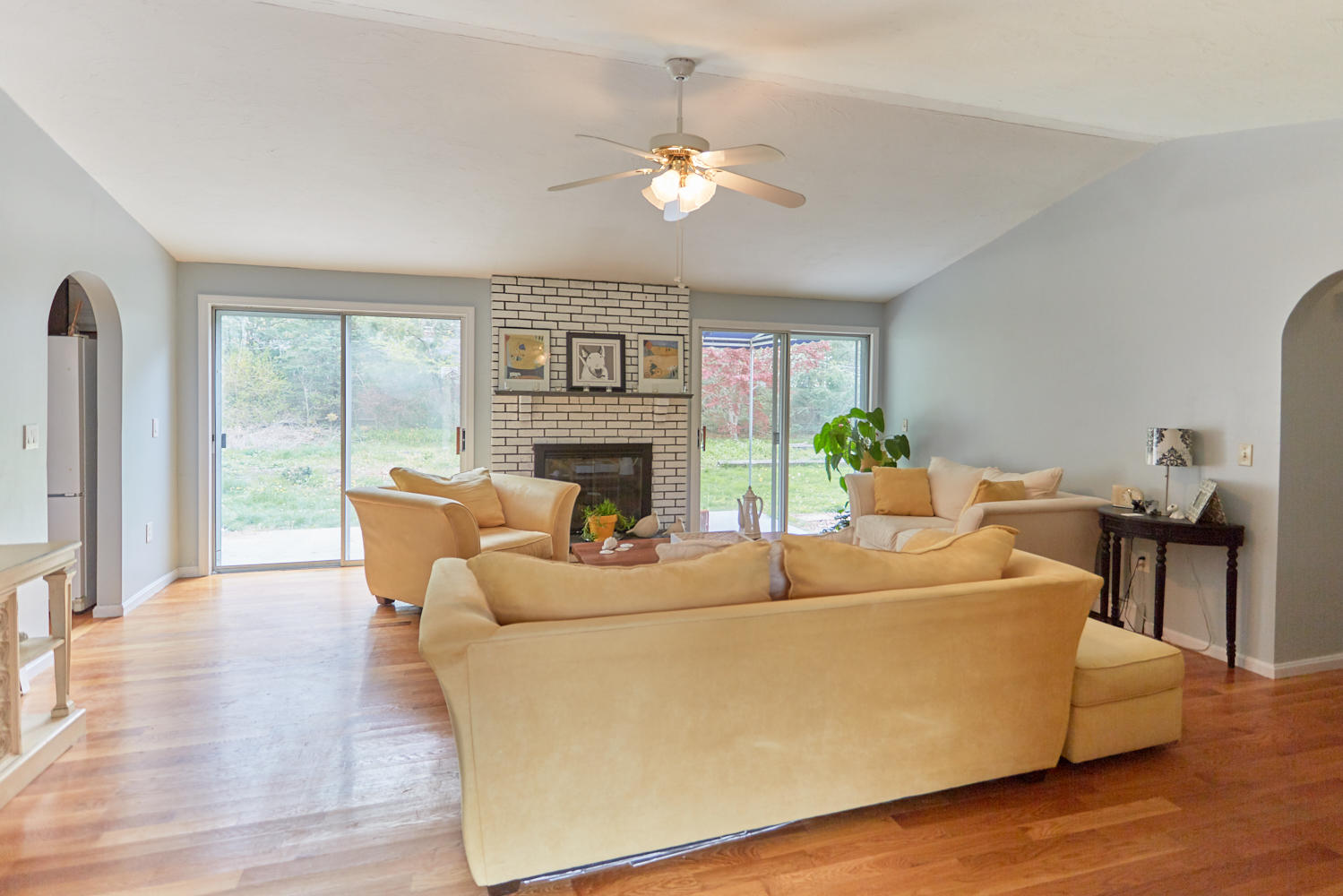 106 Foxglove Road Centerville, MA 02632 - Photo 12 of 23 a living room with furniture a fireplace and a large window
