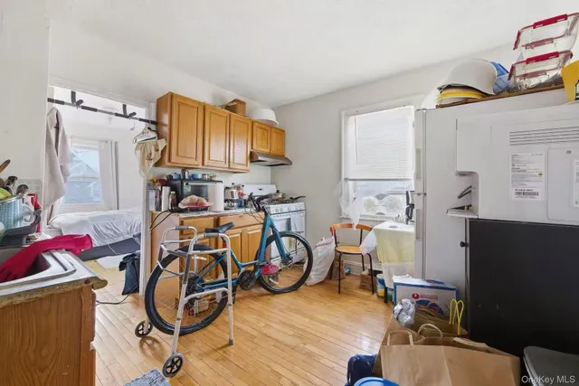 a view of empty room with wooden floor and fireplace