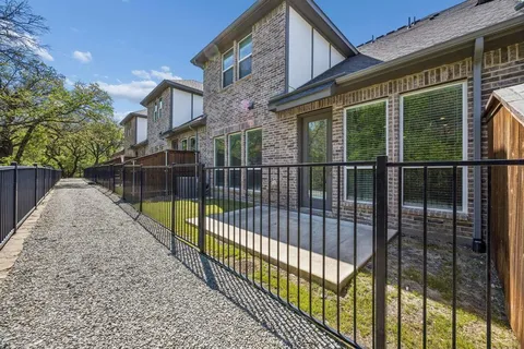 a view of a balcony with a floor to ceiling window and wooden fence