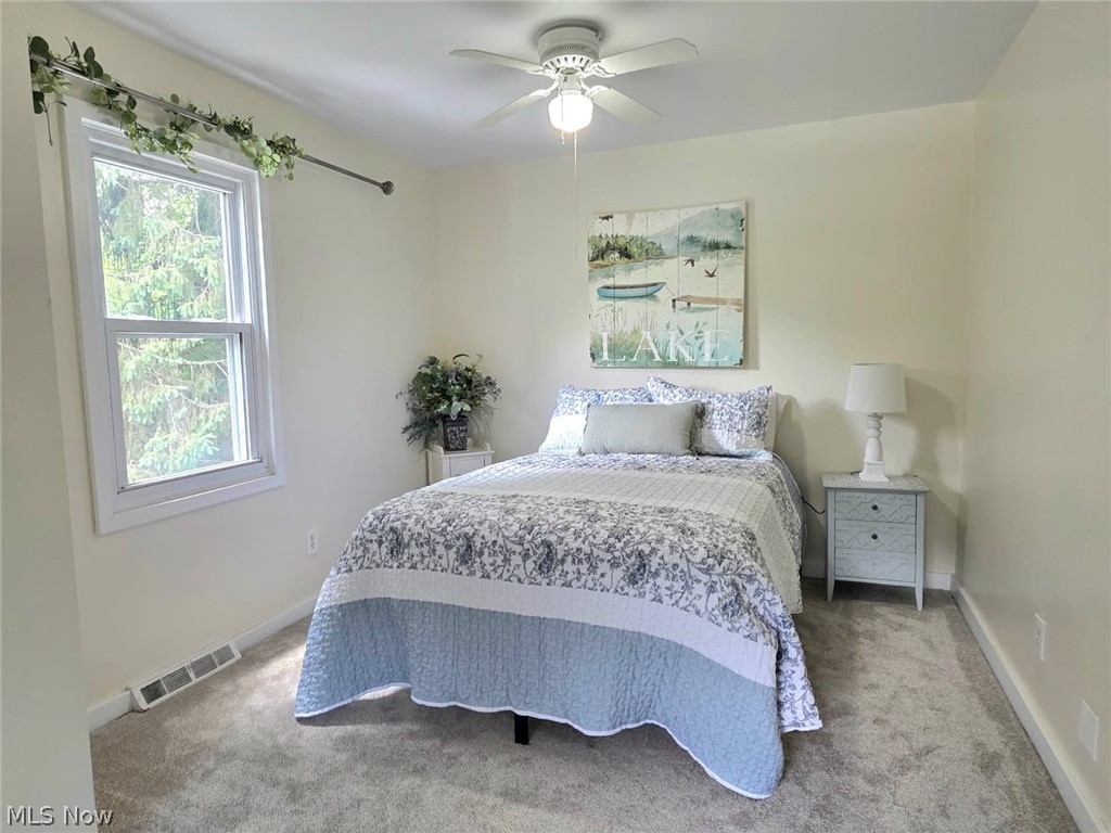 398 North Chillicothe Road Aurora, OH 44202 - Photo 30 of 39 Carpeted room featuring a ceiling fan with integrated lighting, a double-hung window, and neutral wall paint